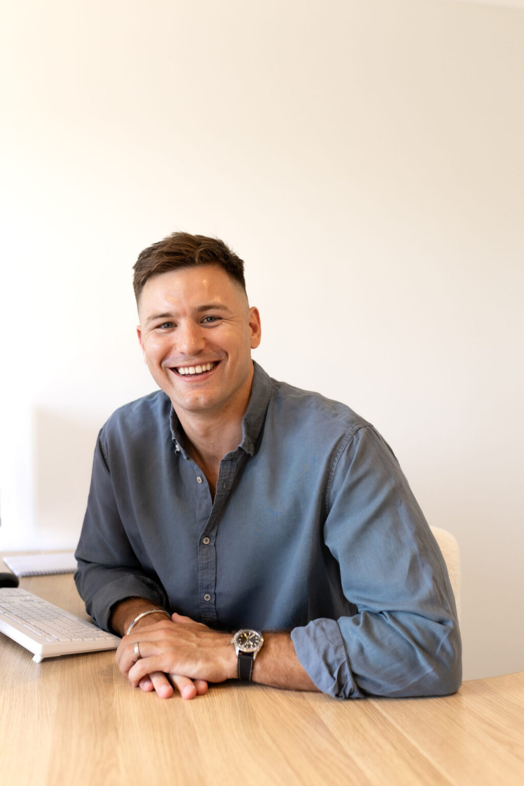 Josh Birch smiling at his desk